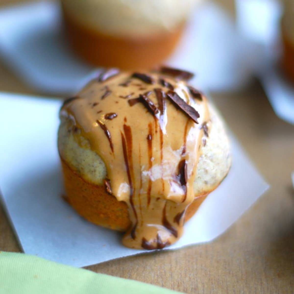 Peanut butter banana flax muffin on a piece of parchment paper.
