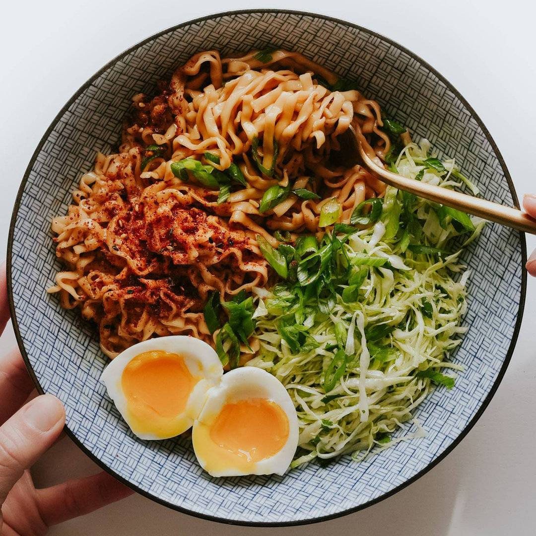 Sesame noodles in a bowl with slaw.