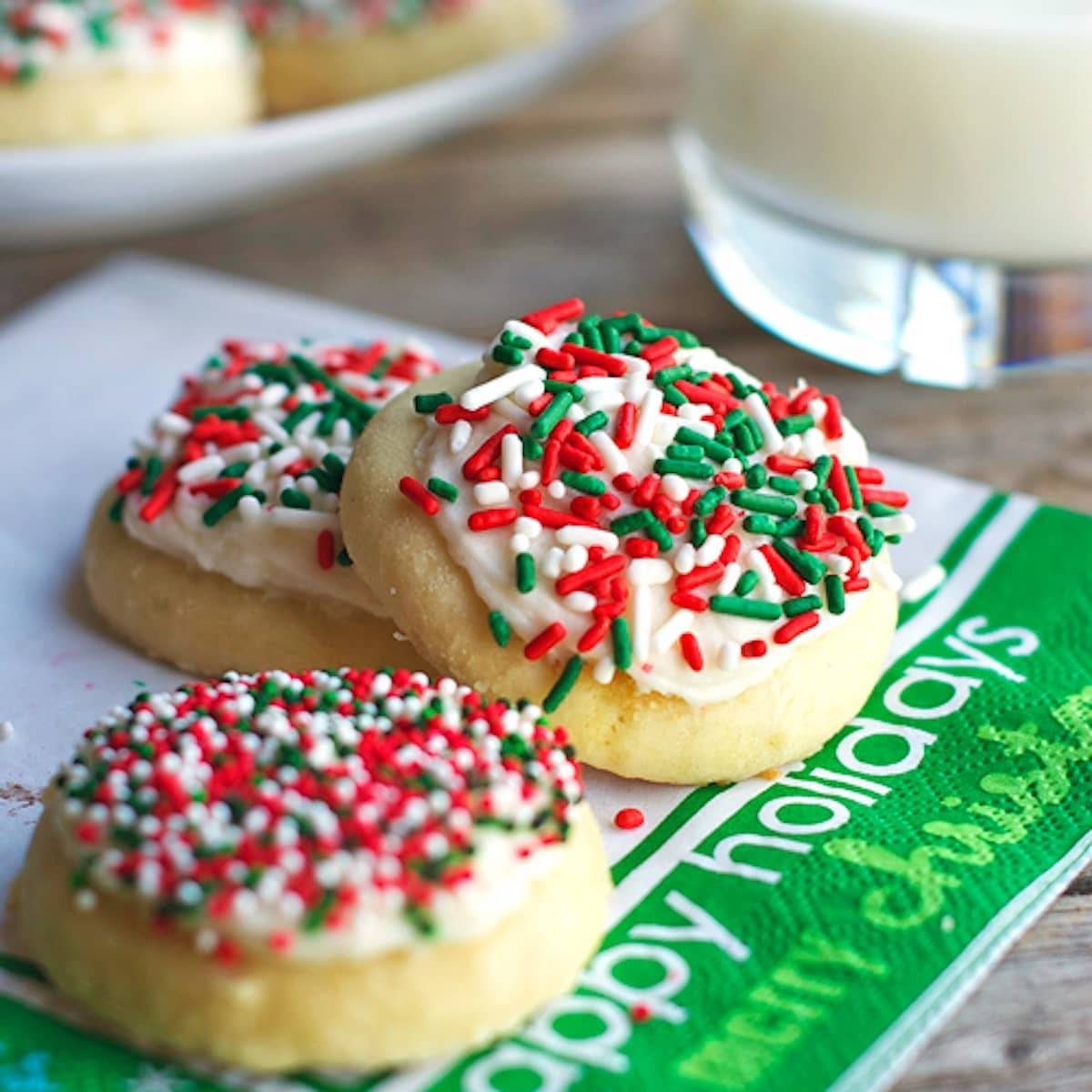 Fluffy sugar cookies topped with a vanilla frosting and sprinkles.