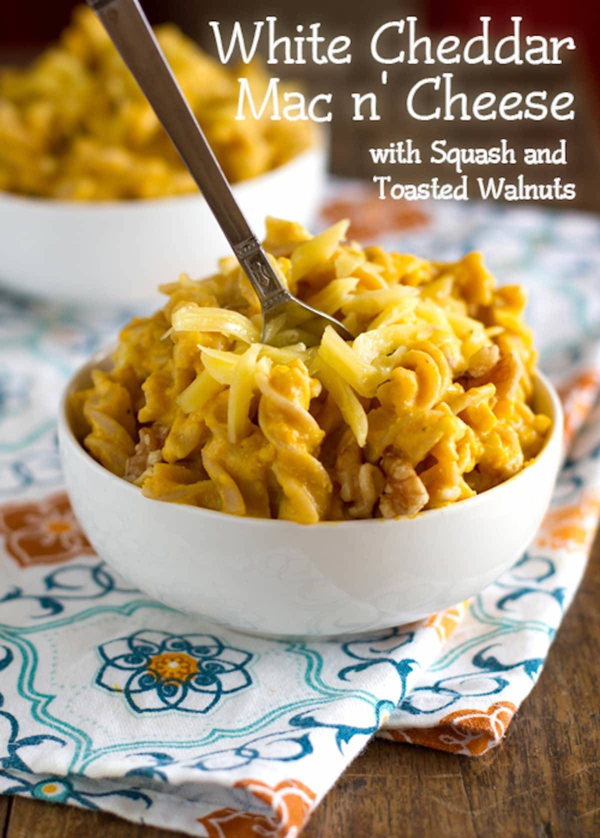 White cheddar mac n' cheese in a bowl on a colorful napkin.